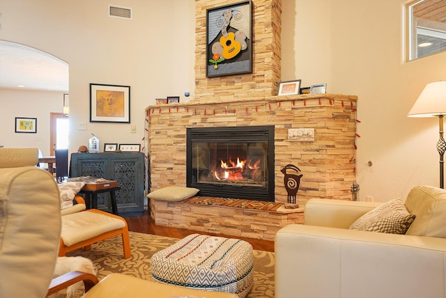 6119 La Paz Rd NE, Rio Rancho, NM 87144 - living area with wood finished floors, a fireplace, and arched walkways