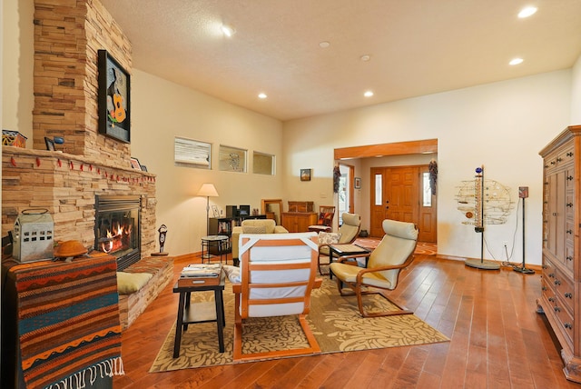 6119 La Paz Rd NE, Rio Rancho, NM 87144 - living room featuring hardwood / wood-style floors, a stone fireplace, and recessed lighting