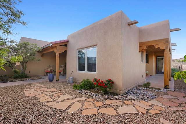 6119 La Paz Rd NE, Rio Rancho, NM 87144 - rear view of house featuring a patio area and stucco siding