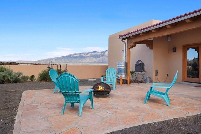 6119 La Paz Rd NE, Rio Rancho, NM 87144 - view of patio featuring an outdoor fire pit and a mountain view