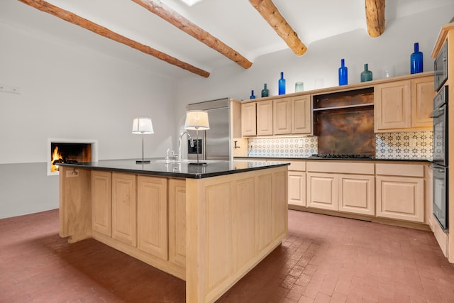 384 Chaparral Ln, Corrales, NM 87048 - kitchen featuring beam ceiling, black appliances, a sink, dark countertops, and decorative backsplash