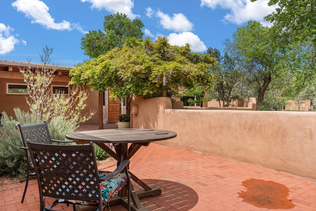 384 Chaparral Ln, Corrales, NM 87048 - view of patio with outdoor dining space and fence