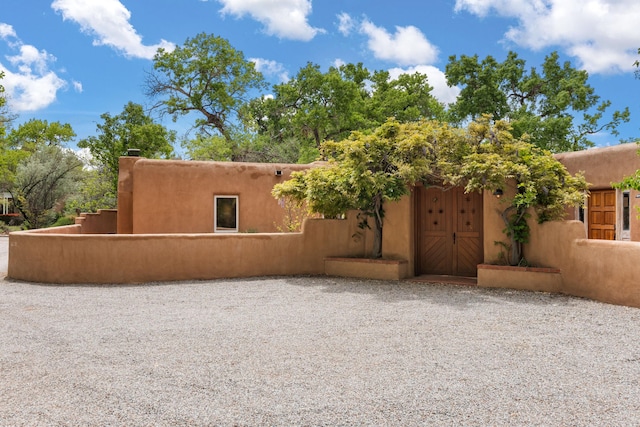384 Chaparral Ln, Corrales, NM 87048 - view of front facade featuring fence and stucco siding
