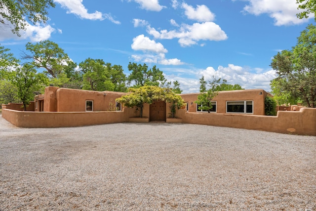 384 Chaparral Ln, Corrales, NM 87048 - rear view of house with stucco siding and fence