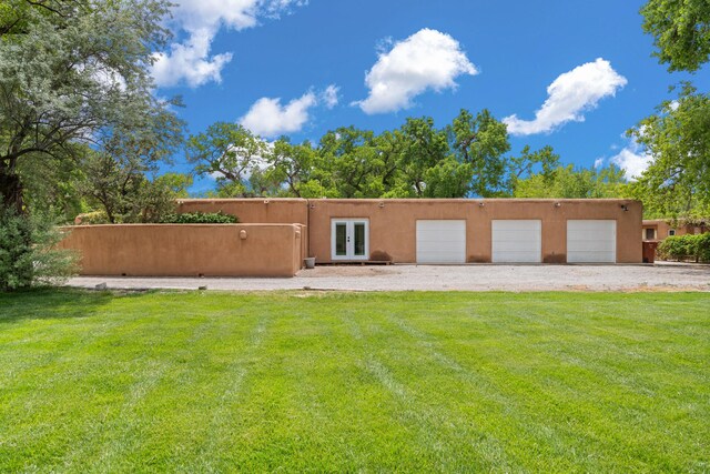 384 Chaparral Ln, Corrales, NM 87048 - view of front of home featuring french doors, a front lawn, and stucco siding
