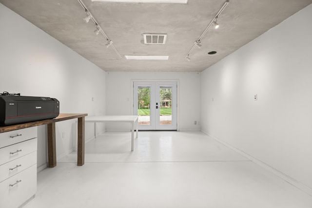 384 Chaparral Ln, Corrales, NM 87048 - interior space with rail lighting, french doors, finished concrete flooring, and baseboards