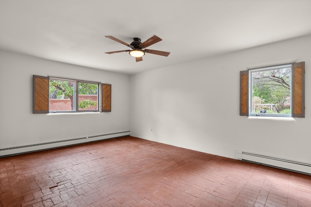 384 Chaparral Ln, Corrales, NM 87048 - unfurnished room featuring a baseboard heating unit, ceiling fan, and brick patterned flooring