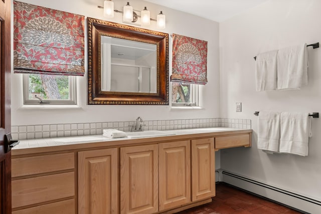 384 Chaparral Ln, Corrales, NM 87048 - bathroom featuring a baseboard radiator, brick patterned floors, a shower with door, vanity, and decorative backsplash