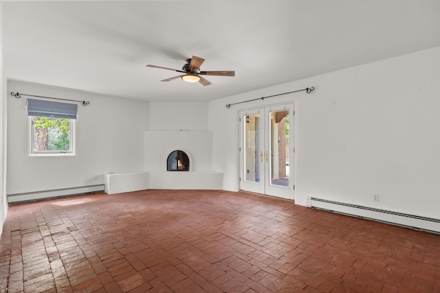 384 Chaparral Ln, Corrales, NM 87048 - unfurnished living room featuring a baseboard radiator, brick floors, a ceiling fan, and a warm lit fireplace