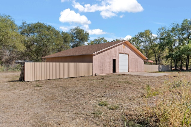 11 Riverside Rd, Peralta, NM 87042 - view of side of home featuring a detached garage, an outbuilding, and a shingled roof