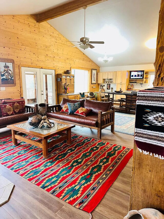 37 Lasso Ln, Pie Town, NM 87827 - living room featuring wood walls, wood finished floors, a ceiling fan, and french doors