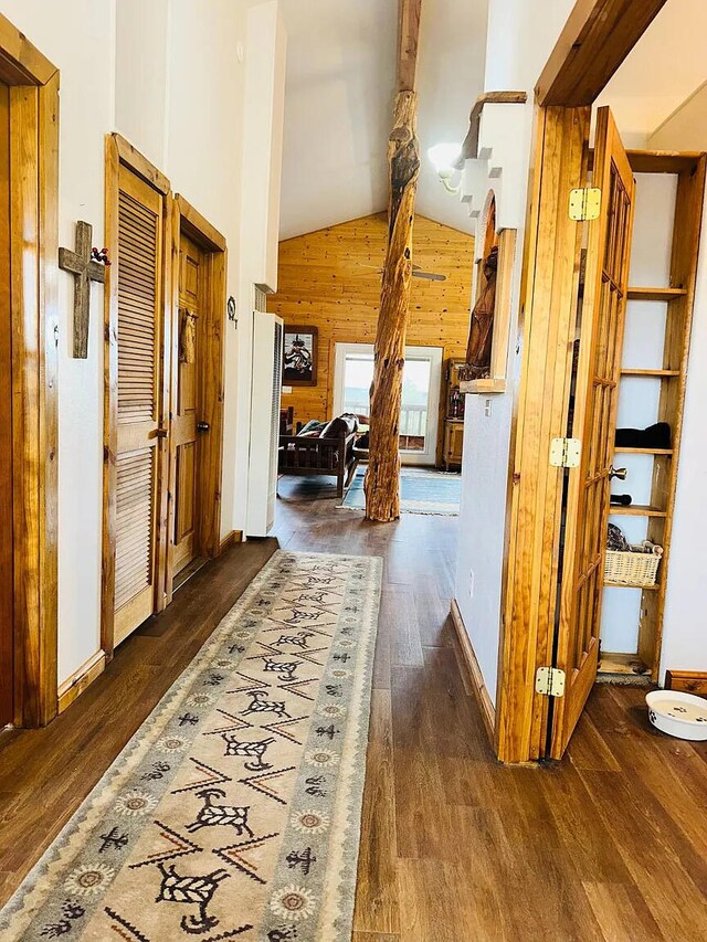 37 Lasso Ln, Pie Town, NM 87827 - hallway with wooden walls, wood finished floors, high vaulted ceiling, beam ceiling, and baseboards