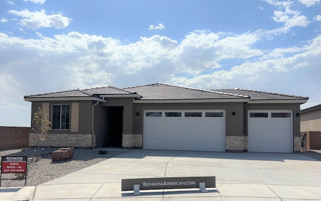 3229 Matador St SE, Rio Rancho, NM 87124 - prairie-style home with stone siding, a garage, driveway, a tile roof, and stucco siding