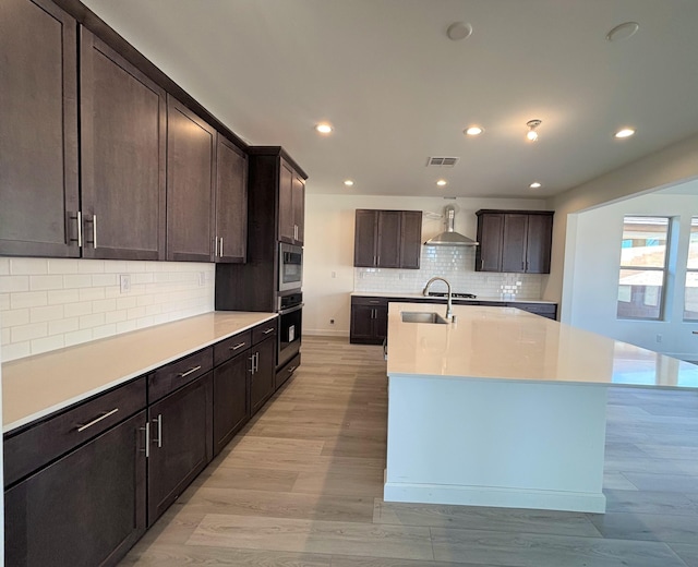 3234 Matador St SE, Rio Rancho, NM 87124 - kitchen with backsplash, a center island with sink, light countertops, stainless steel appliances, and recessed lighting