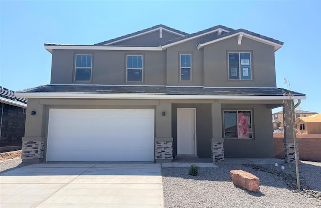 3234 Matador St SE, Rio Rancho, NM 87124 - view of front of property with a porch, stucco siding, stone siding, and an attached garage