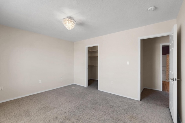 1181 Colibri Ave NW, Los Lunas, NM 87031 - unfurnished bedroom with carpet flooring, baseboards, and a spacious closet
