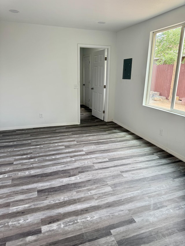 410 Utah St NE, Albuquerque, NM 87108 - unfurnished room with electric panel, wood finished floors, and baseboards