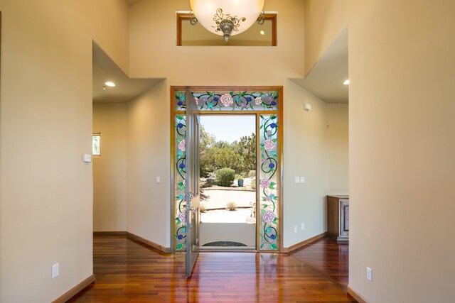 9 Canon Escondido, Sandia Park, NM 87047 - foyer with healthy amount of natural light, wood finished floors, a towering ceiling, and baseboards