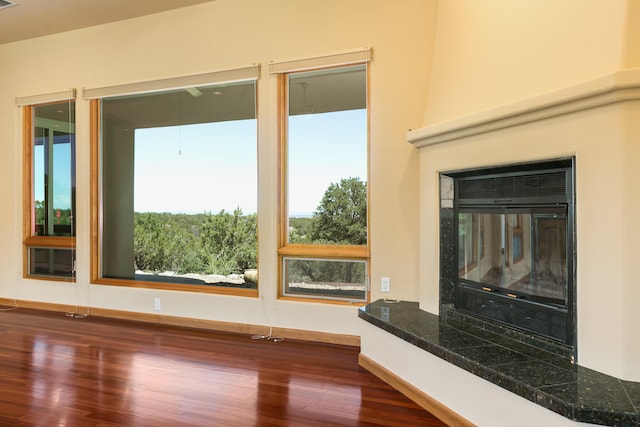 9 Canon Escondido, Sandia Park, NM 87047 - unfurnished living room featuring dark wood-type flooring and baseboards