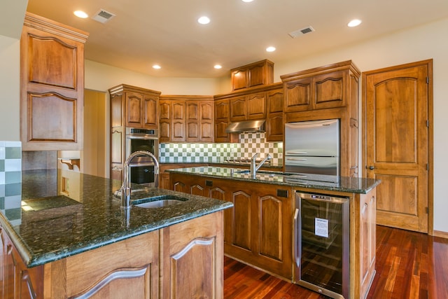9 Canon Escondido, Sandia Park, NM 87047 - kitchen featuring wine cooler, a sink, stainless steel appliances, dark stone countertops, and recessed lighting