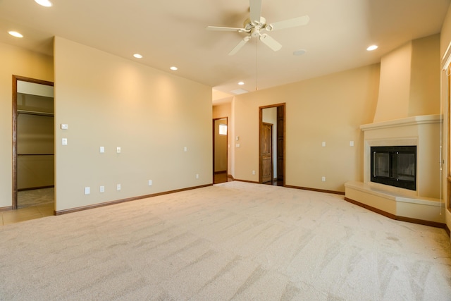 9 Canon Escondido, Sandia Park, NM 87047 - unfurnished living room with carpet floors, recessed lighting, ceiling fan, a large fireplace, and baseboards