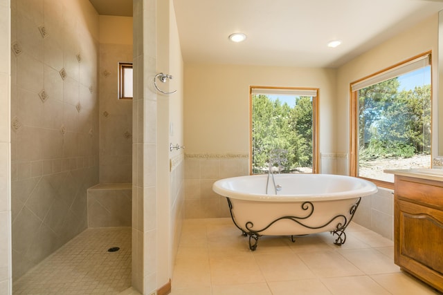9 Canon Escondido, Sandia Park, NM 87047 - full bathroom with a freestanding tub, tile walls, a walk in shower, a wainscoted wall, and vanity