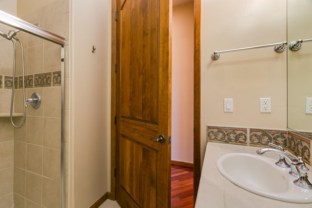 9 Canon Escondido, Sandia Park, NM 87047 - full bathroom featuring a sink, a tile shower, and wood finished floors