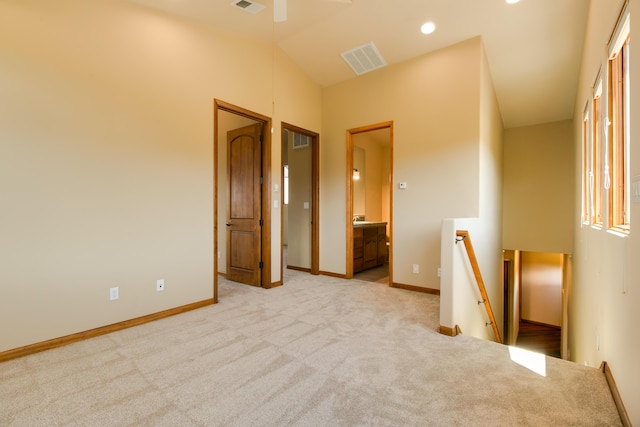 9 Canon Escondido, Sandia Park, NM 87047 - spare room featuring carpet floors, vaulted ceiling, and baseboards