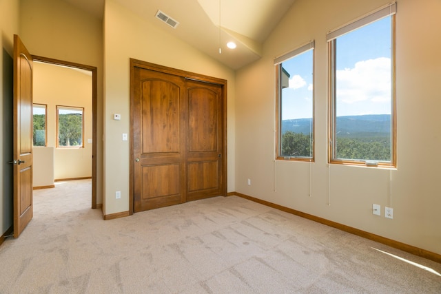 9 Canon Escondido, Sandia Park, NM 87047 - unfurnished bedroom featuring light colored carpet, lofted ceiling, baseboards, and a closet