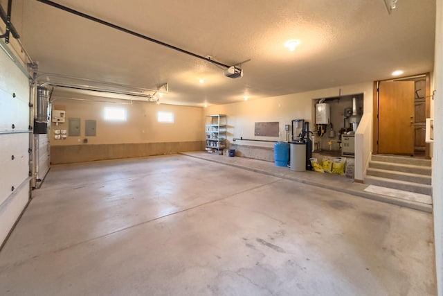 9 Canon Escondido, Sandia Park, NM 87047 - garage featuring electric panel and a garage door opener