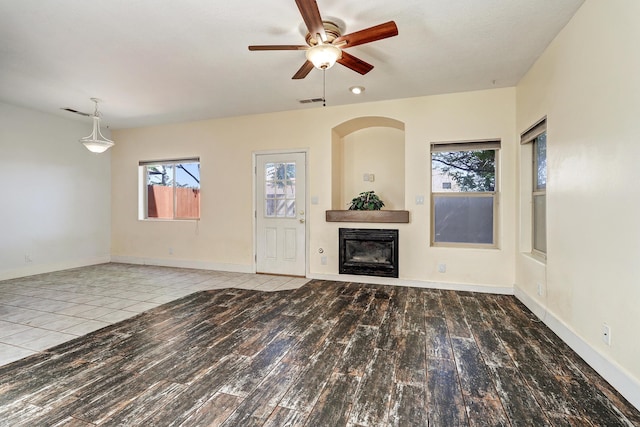 5209 Sugarbear Ct, Albuquerque, NM 87120 - unfurnished living room with a ceiling fan, a glass covered fireplace, wood finished floors, and baseboards