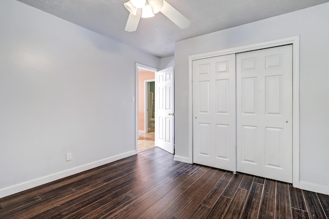 5209 Sugarbear Ct, Albuquerque, NM 87120 - unfurnished bedroom with baseboards, dark wood-style floors, and a closet