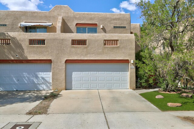 5209 Sugarbear Ct, Albuquerque, NM 87120 - pueblo-style house featuring stucco siding, concrete driveway, and a garage
