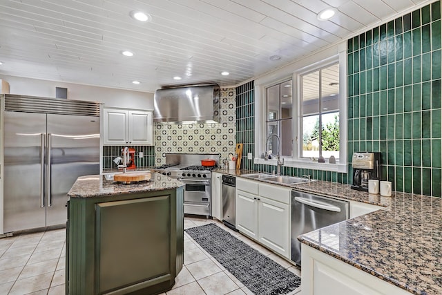 1513 Tinnin Rd NW, Los Ranchos, NM 87107 - kitchen featuring premium appliances, a sink, wall chimney range hood, light tile patterned flooring, and tasteful backsplash