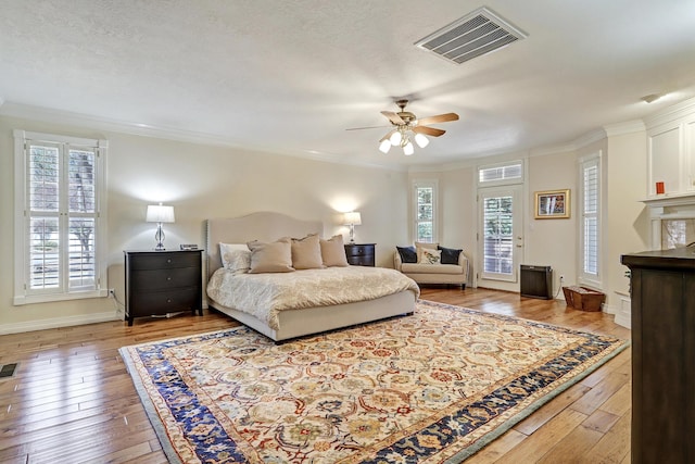 1513 Tinnin Rd NW, Los Ranchos, NM 87107 - bedroom featuring hardwood / wood-style floors, ornamental molding, access to exterior, and ceiling fan