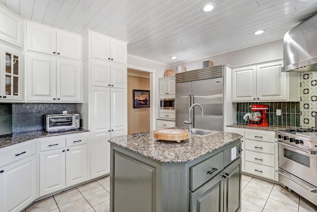 1513 Tinnin Rd NW, Los Ranchos, NM 87107 - kitchen with built in appliances, wall chimney exhaust hood, light tile patterned floors, backsplash, and wood ceiling