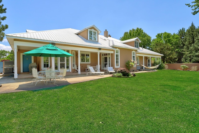 1513 Tinnin Rd NW, Los Ranchos, NM 87107 - back of house with a patio, a chimney, a metal roof, and stucco siding