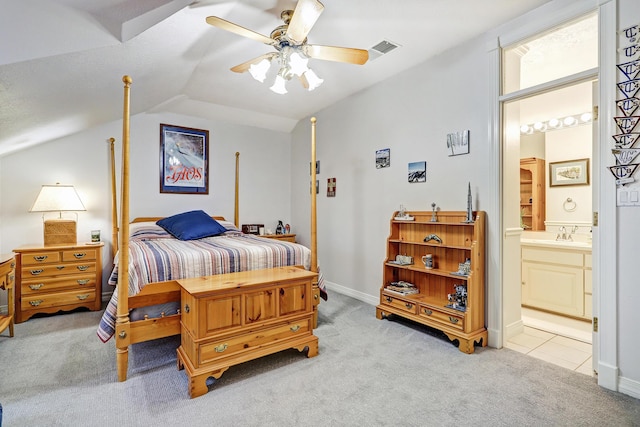 1513 Tinnin Rd NW, Los Ranchos, NM 87107 - bedroom featuring light carpet, vaulted ceiling, ensuite bathroom, a sink, and ceiling fan