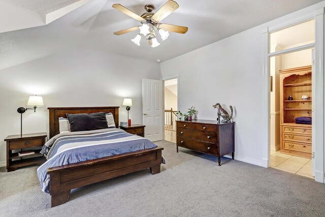 1513 Tinnin Rd NW, Los Ranchos, NM 87107 - carpeted bedroom featuring vaulted ceiling, a ceiling fan, baseboards, and ensuite bathroom