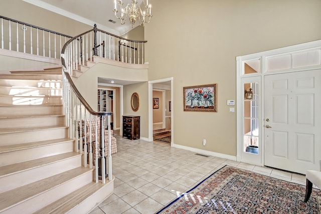 1513 Tinnin Rd NW, Los Ranchos, NM 87107 - entryway featuring light tile patterned flooring, a high ceiling, baseboards, stairway, and a chandelier