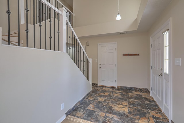 2308 Animas Ct NE, Rio Rancho, NM 87144 - foyer entrance with stone tile flooring, stairs, and baseboards