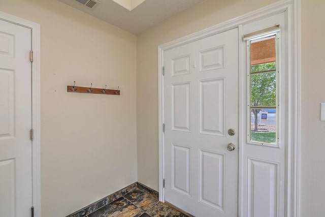 2308 Animas Ct NE, Rio Rancho, NM 87144 - doorway to outside featuring baseboards and dark stone finish floors