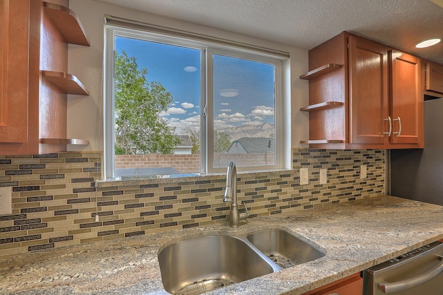 2308 Animas Ct NE, Rio Rancho, NM 87144 - kitchen with a sink, open shelves, stainless steel dishwasher, backsplash, and light stone countertops