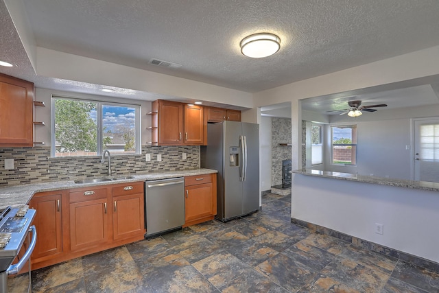 2308 Animas Ct NE, Rio Rancho, NM 87144 - kitchen featuring stainless steel appliances, a sink, open shelves, brown cabinets, and decorative backsplash