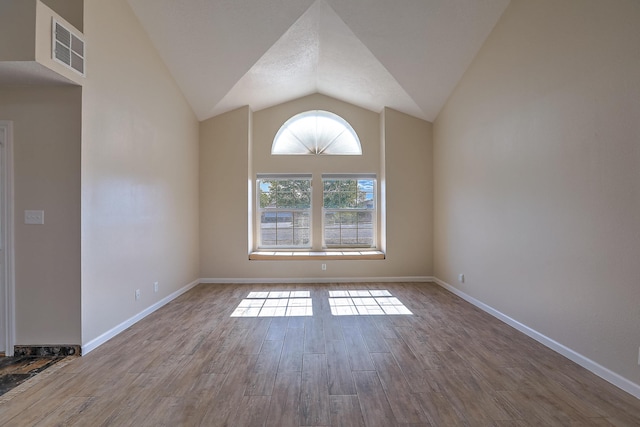2308 Animas Ct NE, Rio Rancho, NM 87144 - spare room featuring vaulted ceiling, wood finished floors, and baseboards