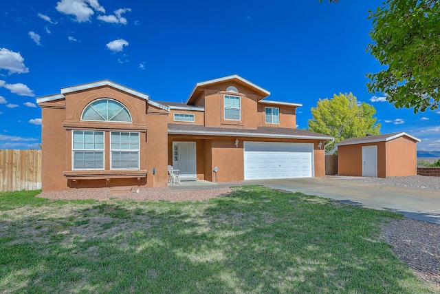 2308 Animas Ct NE, Rio Rancho, NM 87144 - view of front facade with stucco siding, a garage, driveway, a storage unit, and an outbuilding