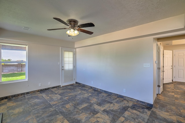 2308 Animas Ct NE, Rio Rancho, NM 87144 - spare room with ceiling fan, baseboards, stone finish floors, and a textured ceiling