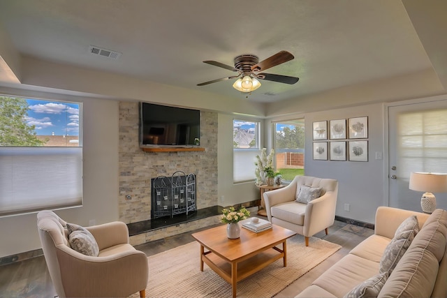 2308 Animas Ct NE, Rio Rancho, NM 87144 - living room featuring a large fireplace, plenty of natural light, and wood finished floors