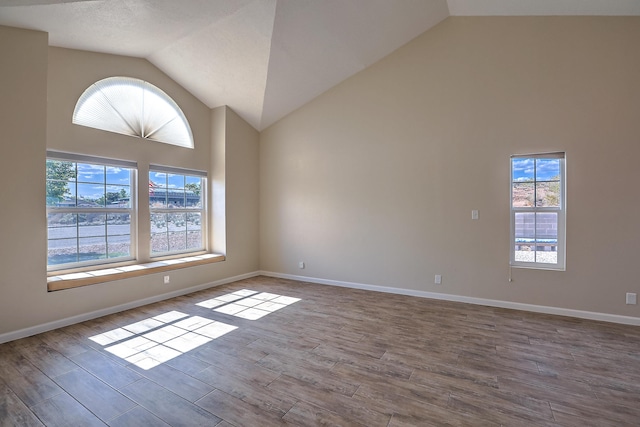 2308 Animas Ct NE, Rio Rancho, NM 87144 - empty room with high vaulted ceiling, wood finished floors, and baseboards
