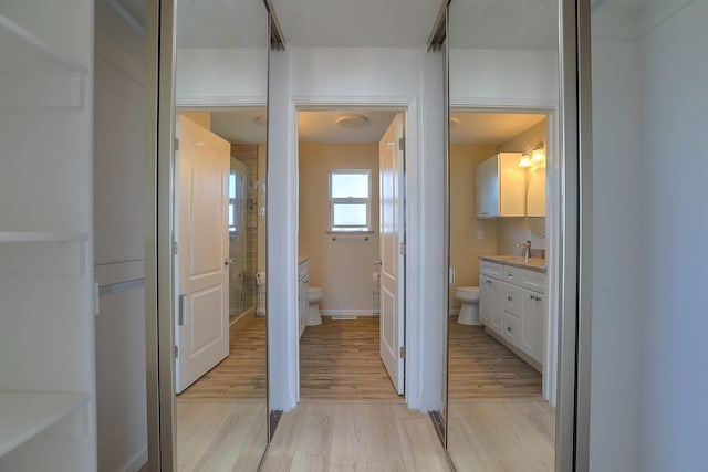 2308 Animas Ct NE, Rio Rancho, NM 87144 - bathroom featuring toilet, wood finished floors, vanity, a shower with door, and baseboards